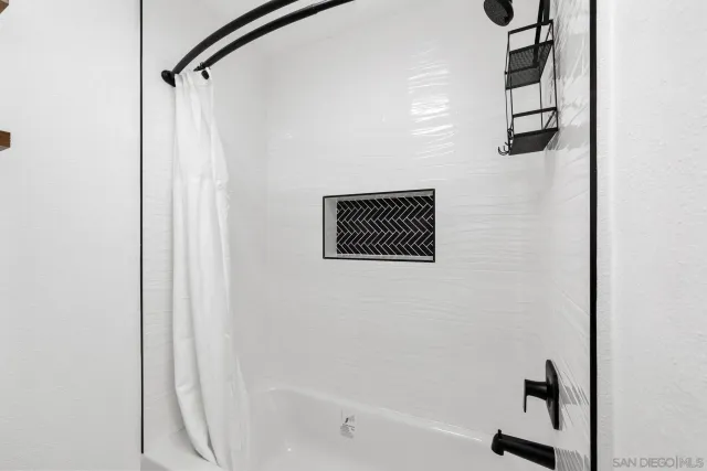 a bathroom with a shower and a bathtub