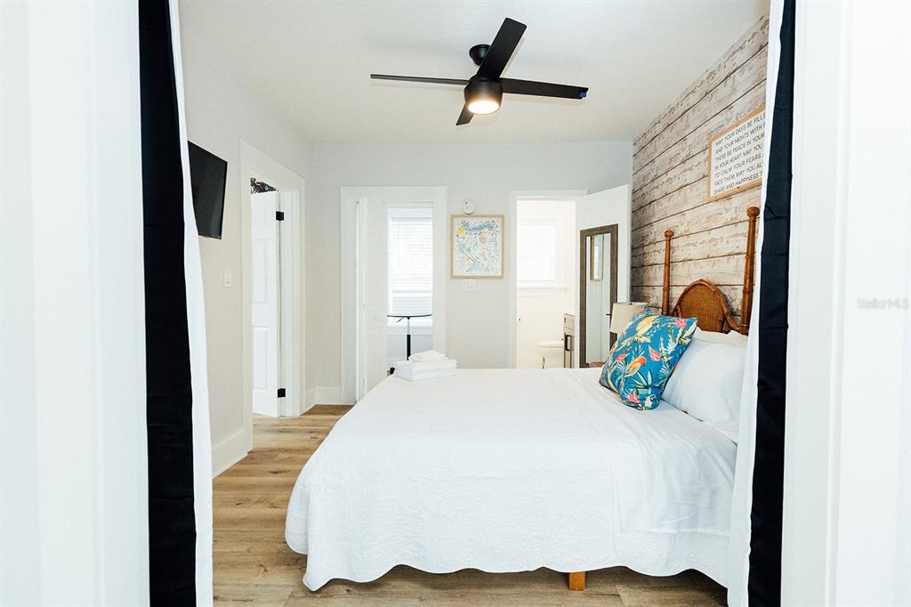 809 10th Avenue North, Unit 3 St. Petersburg, FL 33701 - Photo 14 of 47 a bedroom with a bed and ceiling fan