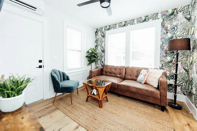 a living room with furniture and a potted plant