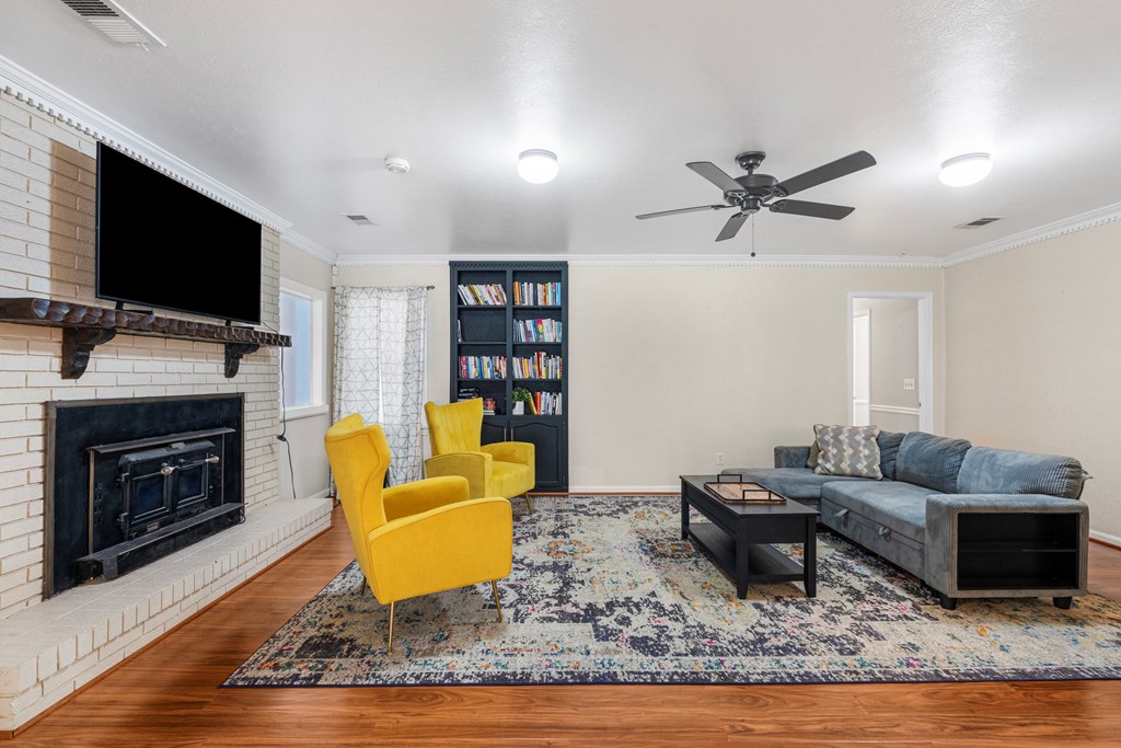 7310 Macon Road Columbus, GA 31907 - Photo 11 of 28 a living room with furniture a flat screen tv and a fireplace