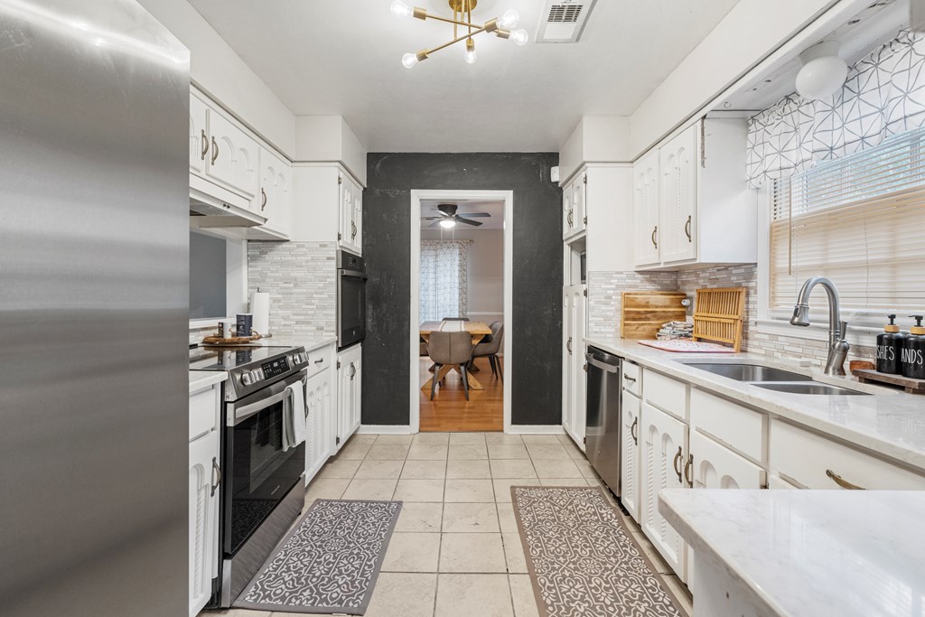 7310 Macon Road Columbus, GA 31907 - Photo 13 of 28 a kitchen with stainless steel appliances granite countertop a sink and cabinets
