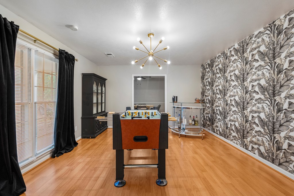 7310 Macon Road Columbus, GA 31907 - Photo 16 of 28 a living room with furniture and a chandelier