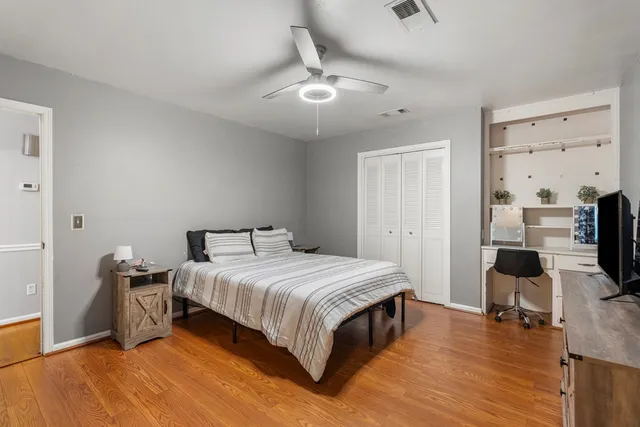 a bedroom with a bed and wooden floor