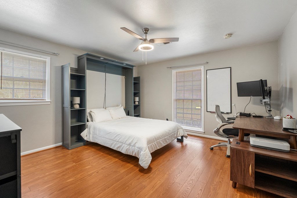 7310 Macon Road Columbus, GA 31907 - Photo 21 of 28 a bedroom with a bed and a large window