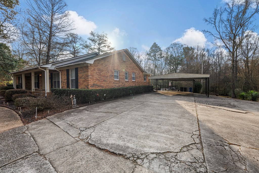 7310 Macon Road Columbus, GA 31907 - Photo 4 of 28 a view of a white house with a sink and a yard