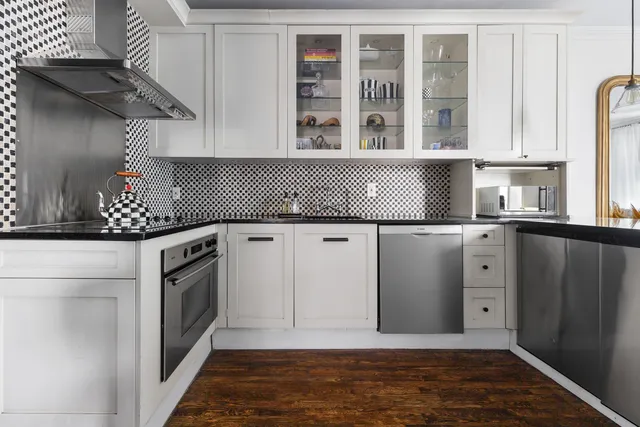 a kitchen with stainless steel appliances granite countertop a sink and a stove