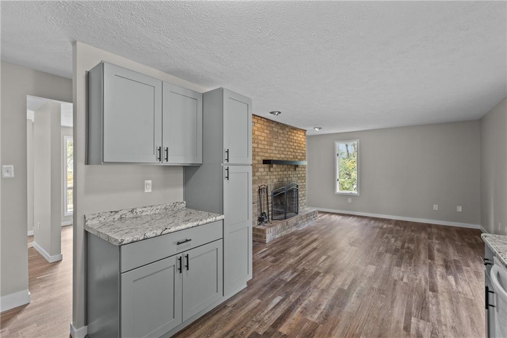 7440 Noblestown Road McDonald, PA 15057 - Photo 11 of 38 a kitchen with granite countertop a stove top oven a sink dishwasher and a refrigerator with wooden floor