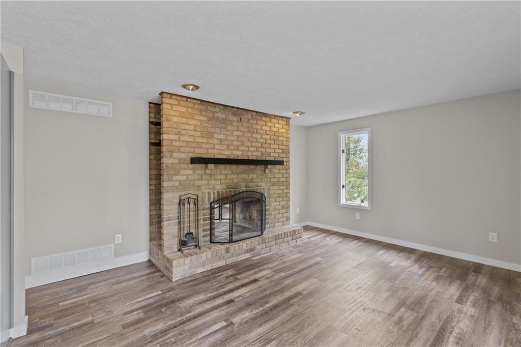 7440 Noblestown Road McDonald, PA 15057 - Photo 12 of 38 a view of empty room with wooden floor and fireplace