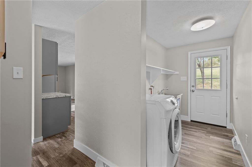 7440 Noblestown Road McDonald, PA 15057 - Photo 19 of 38 a view of entryway with hallway and wooden floor