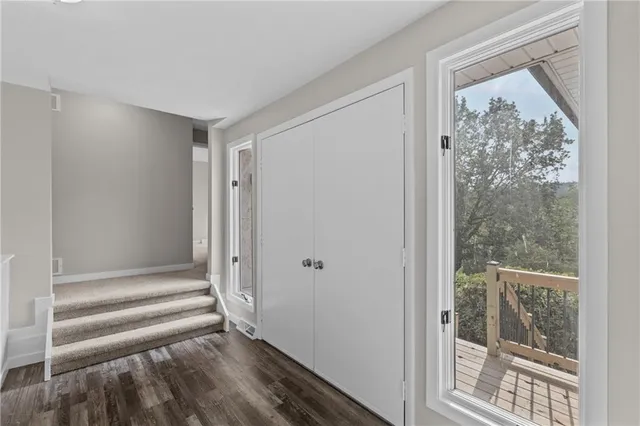 a view of a livingroom with wooden floor and a window