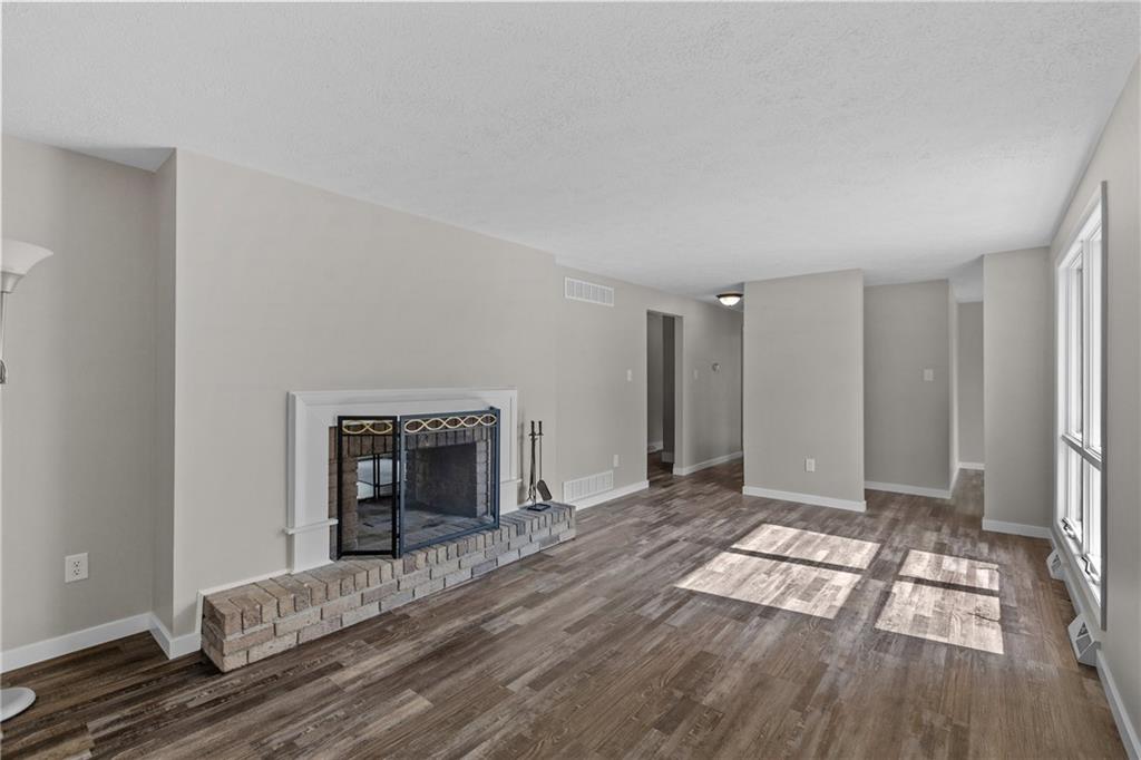 7440 Noblestown Road McDonald, PA 15057 - Photo 5 of 38 a view of an empty room with wooden floor and a fireplace