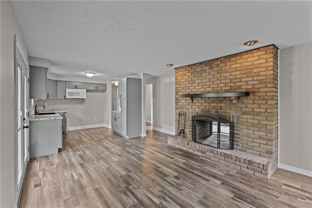 7440 Noblestown Road McDonald, PA 15057 - Photo 7 of 38 a view of a kitchen with a sink and a fireplace