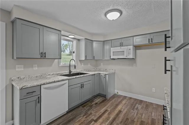 a kitchen with a sink cabinets and window