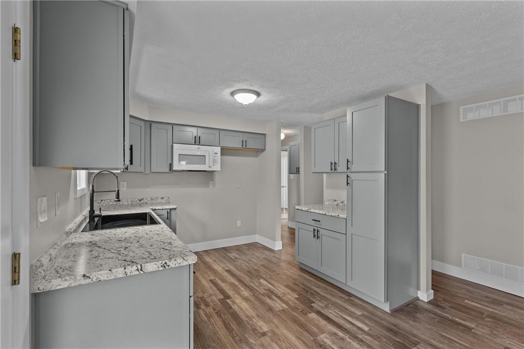 7440 Noblestown Road McDonald, PA 15057 - Photo 10 of 38 a kitchen with white cabinets and stainless steel appliances