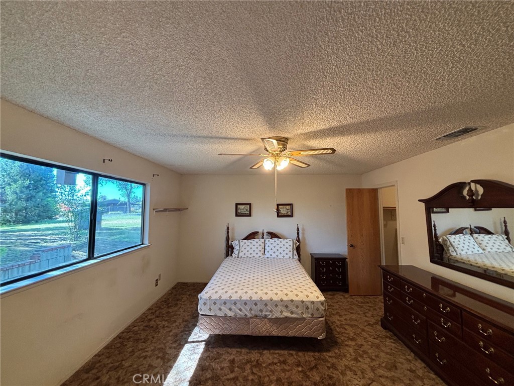 4918 Indian Peak Road Mariposa, CA 95338 - Photo 18 of 39 a spacious bedroom with a bed and window