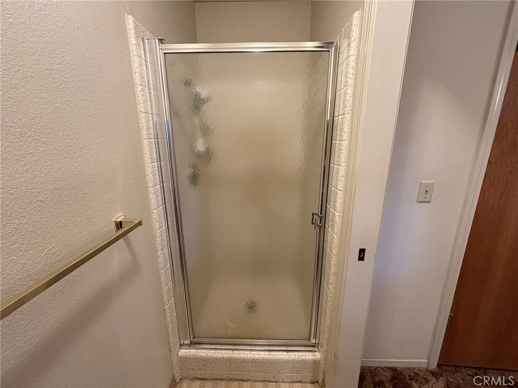 4918 Indian Peak Road Mariposa, CA 95338 - Photo 25 of 39 a bathroom with a glass shower door