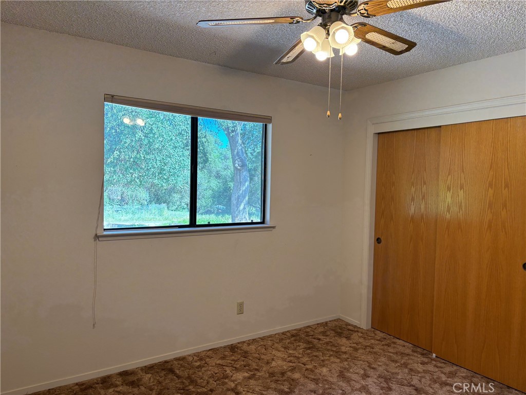4918 Indian Peak Road Mariposa, CA 95338 - Photo 28 of 39 a bedroom with a window and a ceiling fan