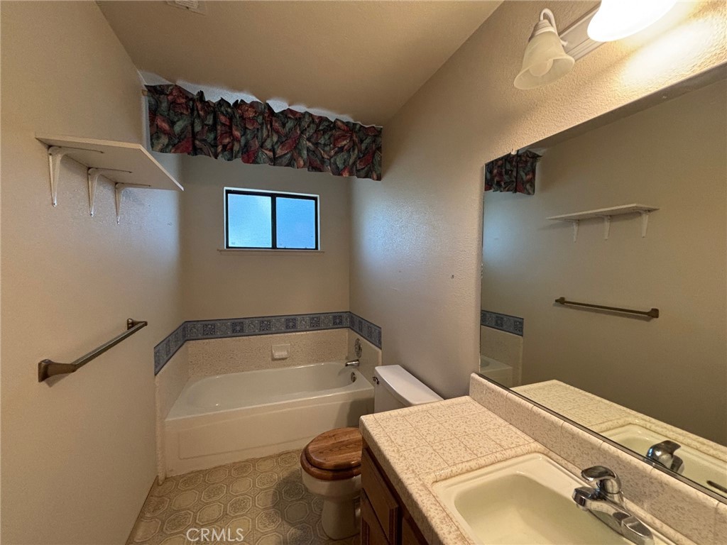 4918 Indian Peak Road Mariposa, CA 95338 - Photo 29 of 39 a bathroom with a sink and a bathtub