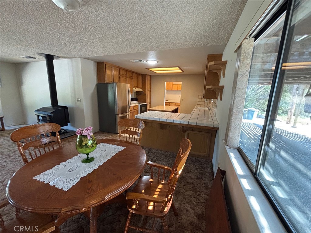4918 Indian Peak Road Mariposa, CA 95338 - Photo 10 of 39 a view of a dining room with furniture a chandelier and wooden floor