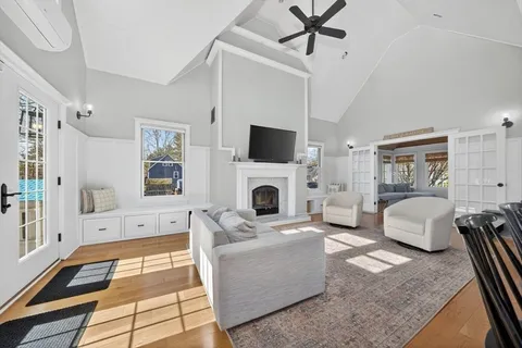 a living room with fireplace furniture and a table