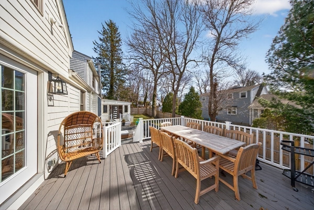 12 Tupelo Road Cohasset, MA 02025 - Photo 12 of 35 a view of a roof deck with table and chairs and wooden floor