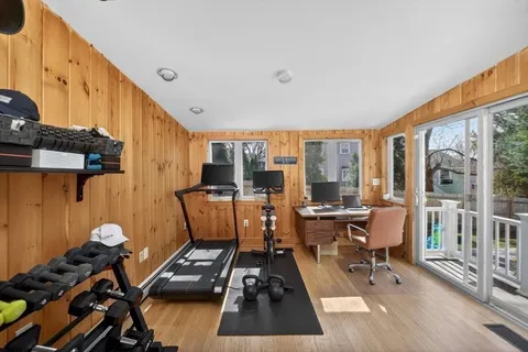 a living room with furniture a fireplace and a open kitchen view