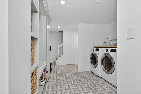 a view of a patio with table and chairs potted plants and large tree