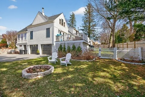 a view of swimming pool with large trees and a big yard
