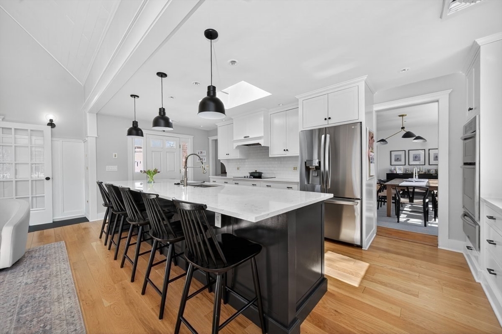 12 Tupelo Road Cohasset, MA 02025 - Photo 6 of 35 a kitchen with stainless steel appliances a dining table chairs stove and refrigerator