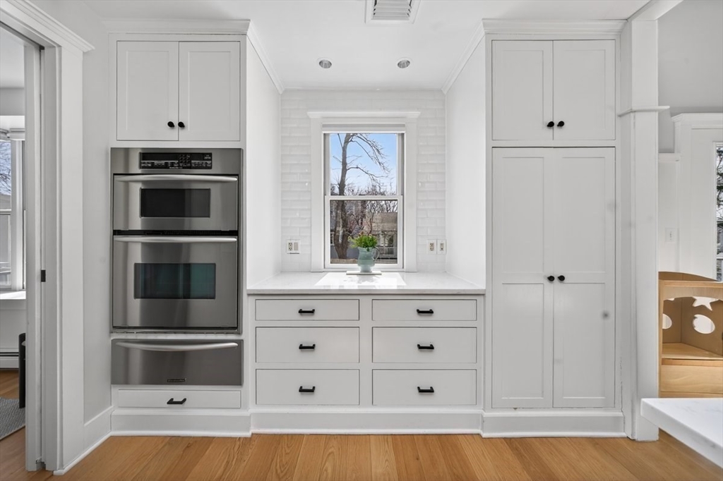 12 Tupelo Road Cohasset, MA 02025 - Photo 9 of 35 a kitchen with white cabinets and stainless steel appliances