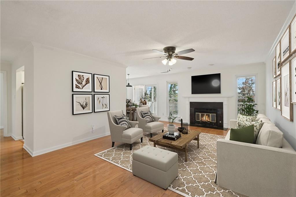a living room with furniture a fireplace and a flat screen tv