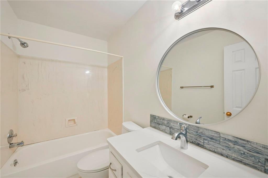 1750 Clairmont Road, Unit 21 Decatur, GA 30033 - Photo 12 of 23 a bathroom with a sink a toilet and a mirror