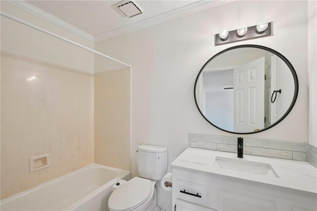 1750 Clairmont Road, Unit 21 Decatur, GA 30033 - Photo 16 of 23 a bathroom with a toilet sink and mirror