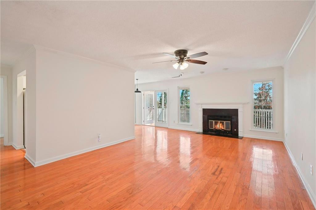 1750 Clairmont Road, Unit 21 Decatur, GA 30033 - Photo 2 of 23 a view of an empty room with wooden floor fireplace and a window