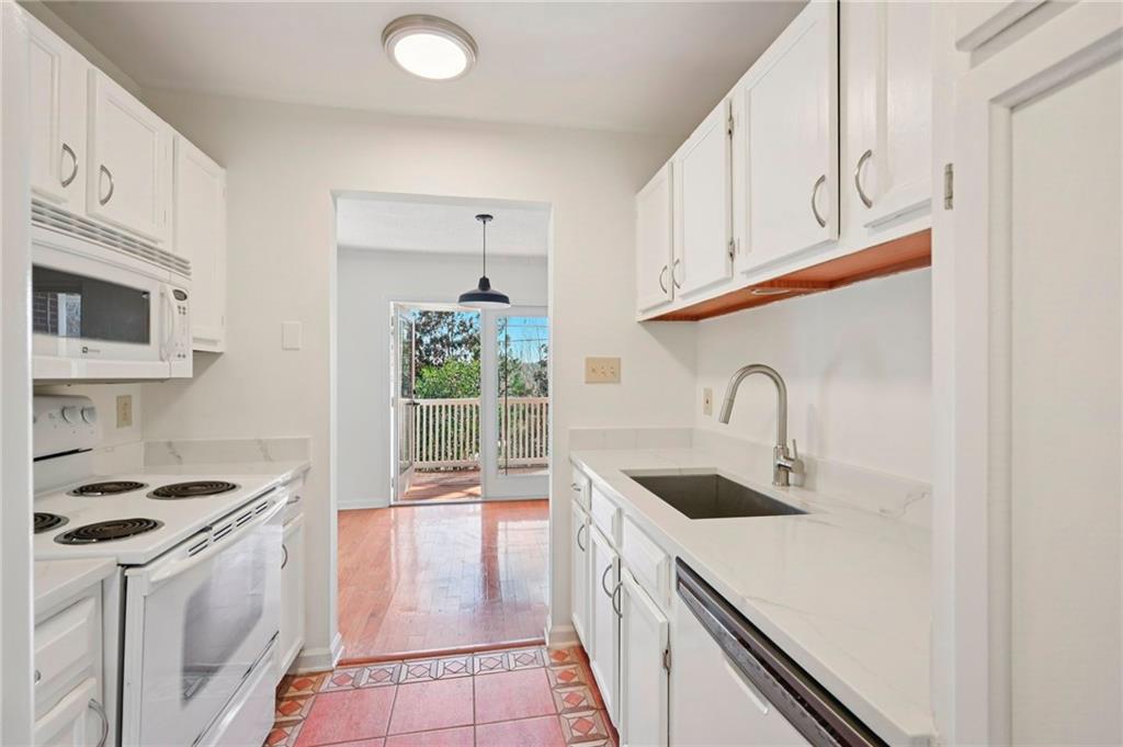 1750 Clairmont Road, Unit 21 Decatur, GA 30033 - Photo 7 of 23 a kitchen with stainless steel appliances granite countertop a sink stove and refrigerator
