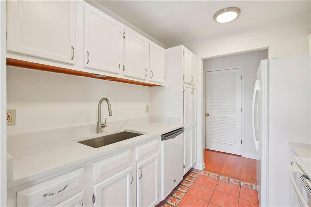 1750 Clairmont Road, Unit 21 Decatur, GA 30033 - Photo 8 of 23 a kitchen with stainless steel appliances granite countertop a sink and a refrigerator