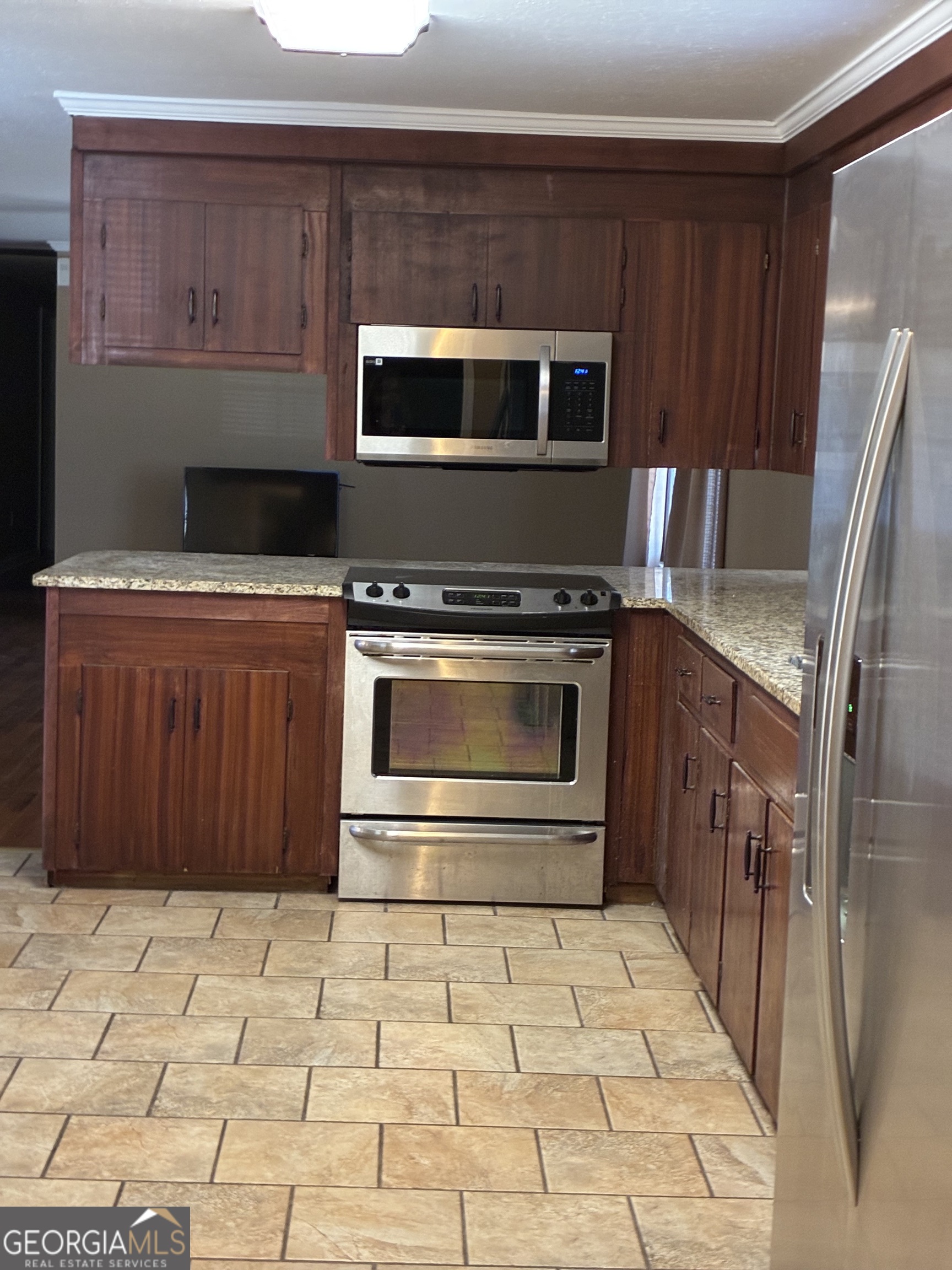 3491 Sandy Circle Macon, GA 31216 - Photo 12 of 49 a kitchen with stainless steel appliances granite countertop a stove a microwave and a sink