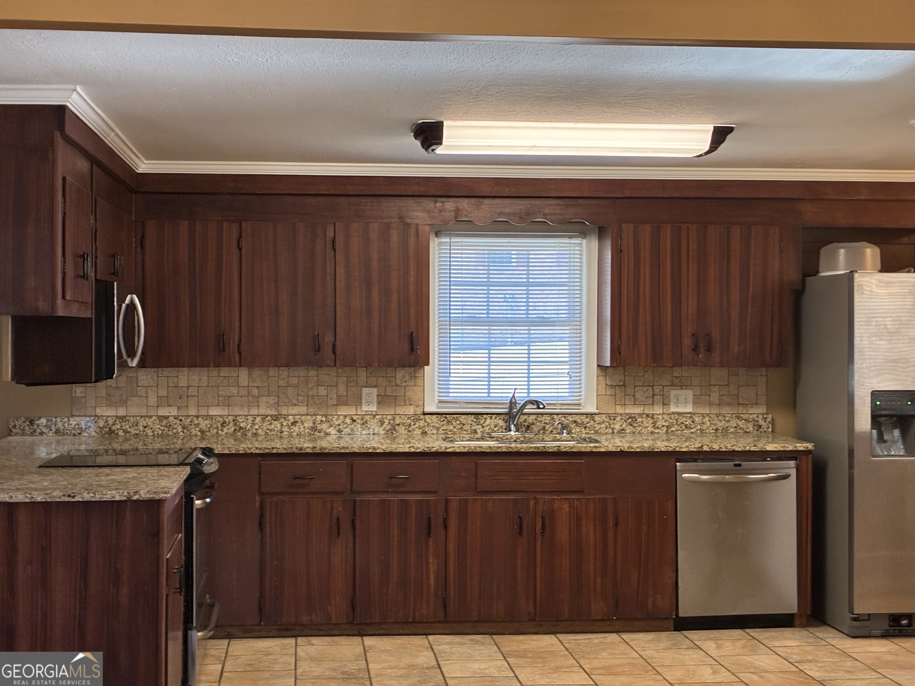 3491 Sandy Circle Macon, GA 31216 - Photo 14 of 49 a kitchen with granite countertop stainless steel appliances a sink and a counter top space