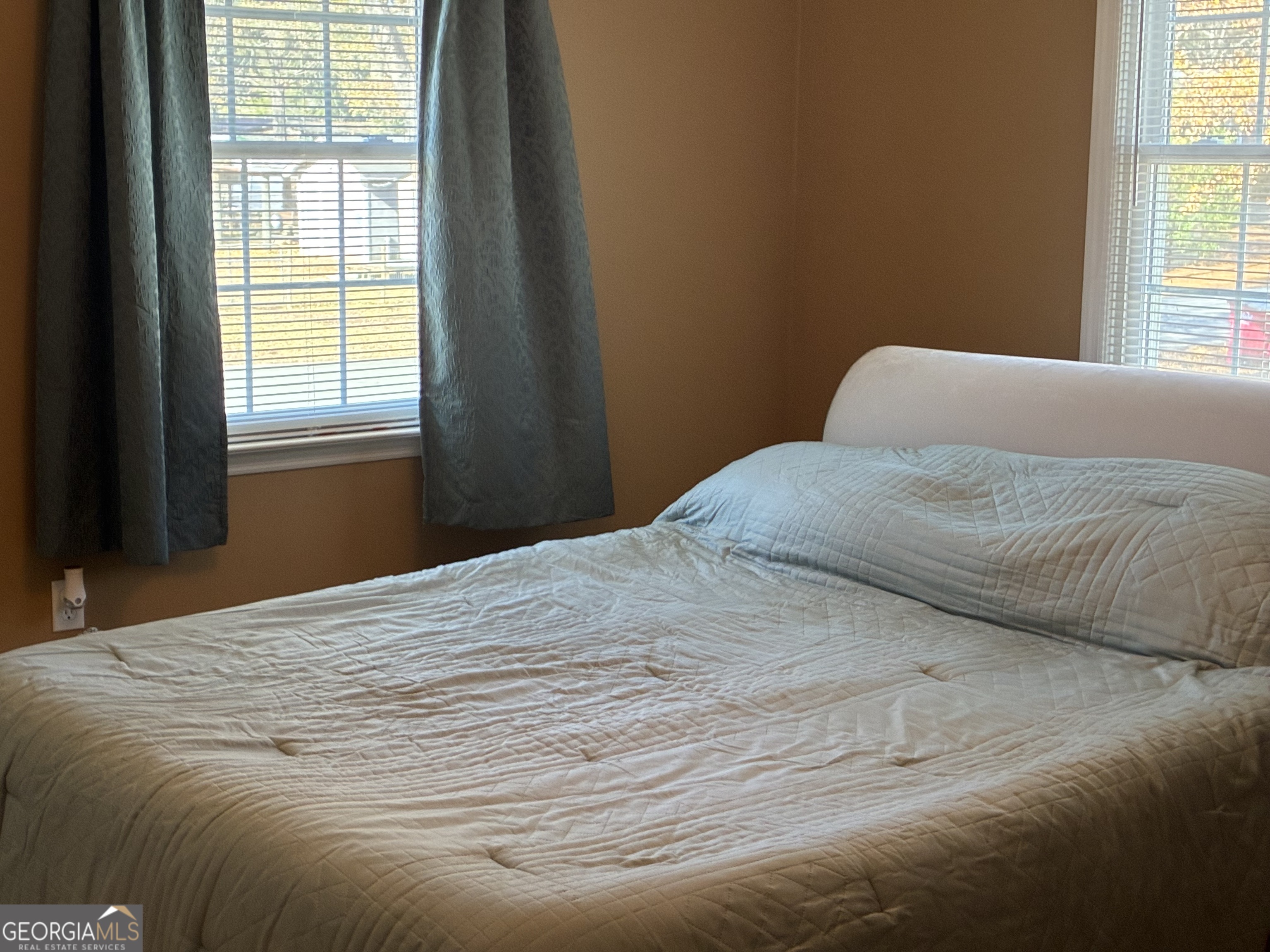 3491 Sandy Circle Macon, GA 31216 - Photo 18 of 49 a bedroom with a bed and wooden floor