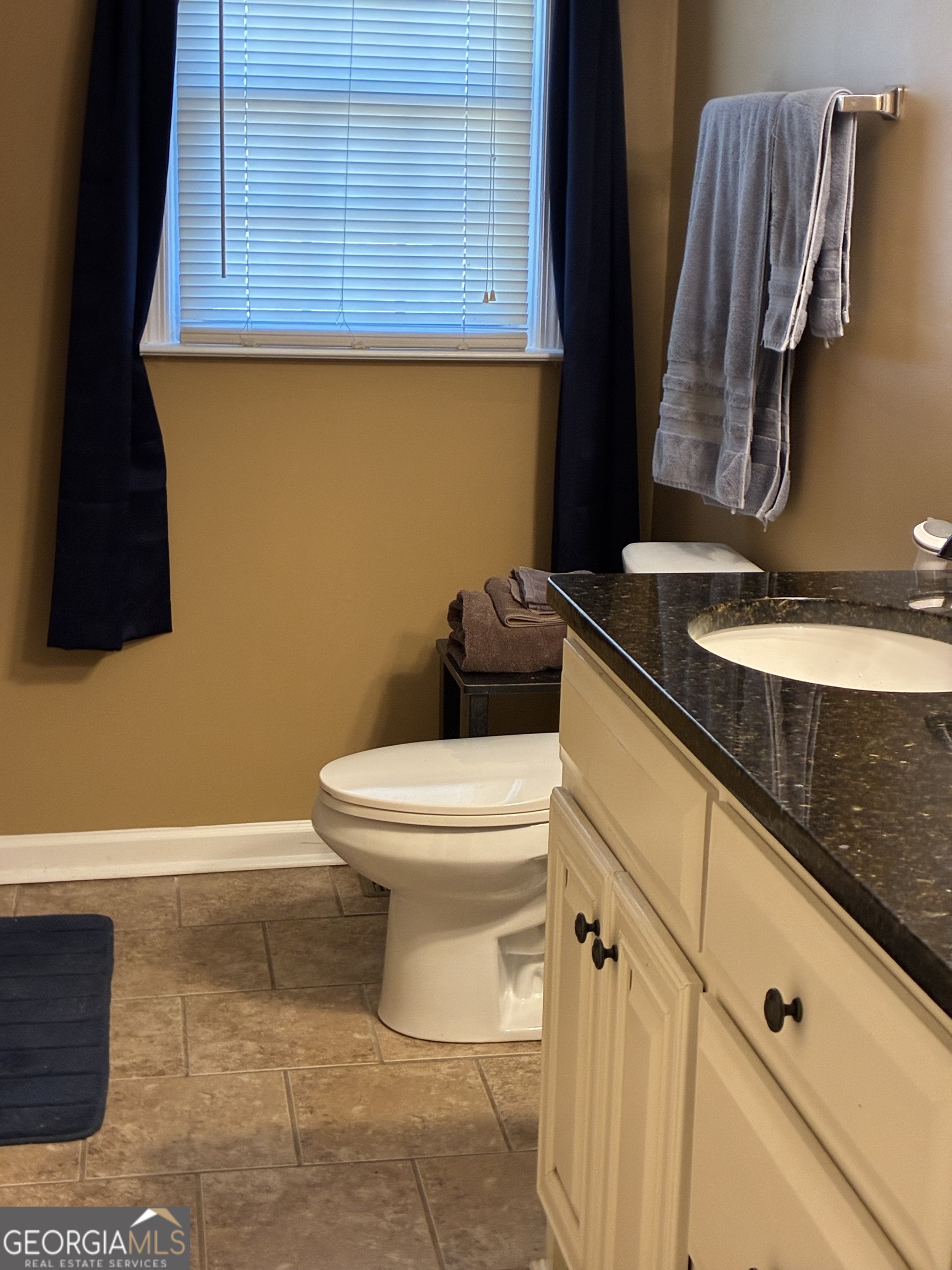 3491 Sandy Circle Macon, GA 31216 - Photo 31 of 49 a bathroom with a granite countertop toilet and a sink