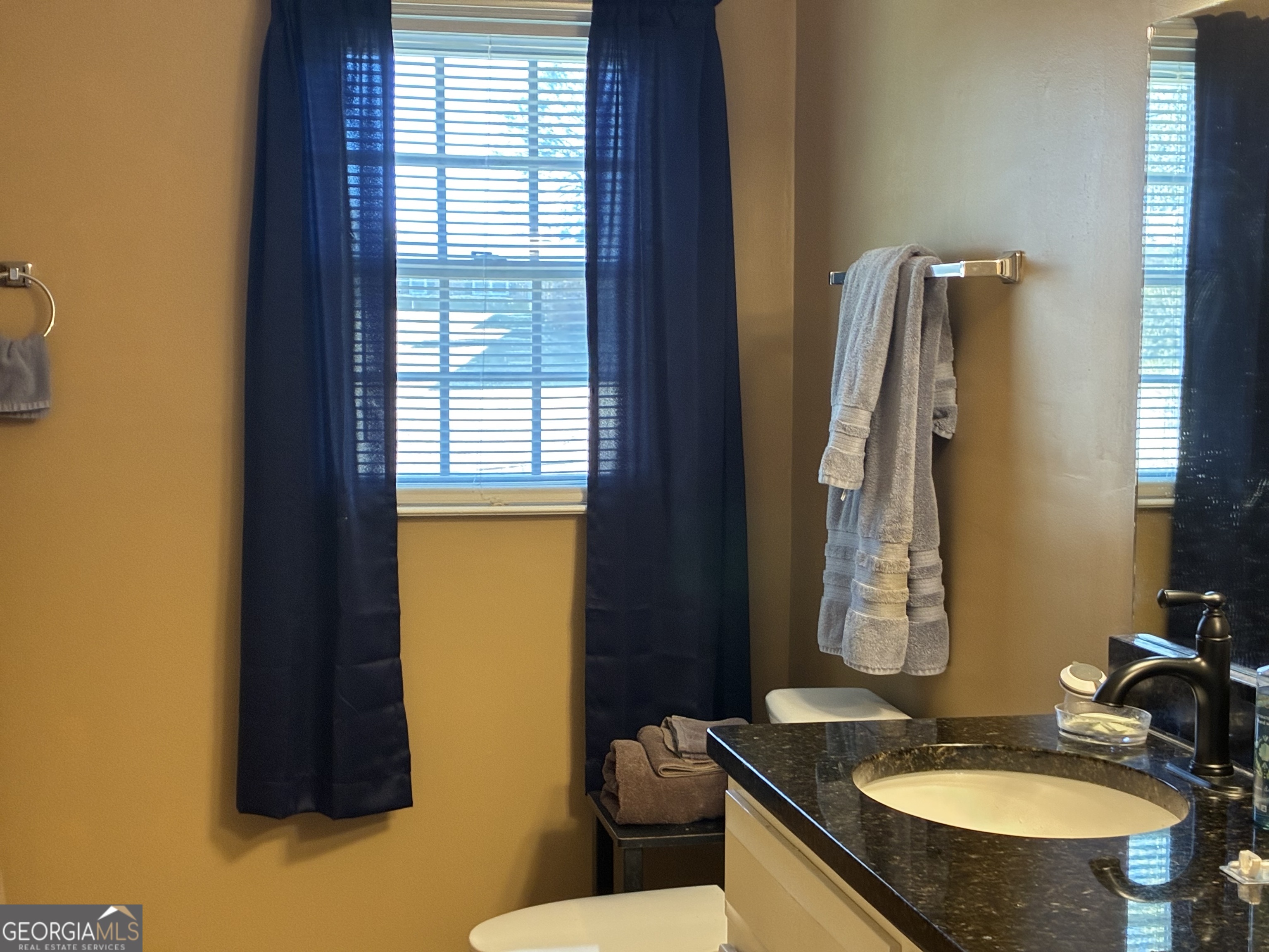 3491 Sandy Circle Macon, GA 31216 - Photo 36 of 49 a bathroom with a granite countertop sink and a mirror