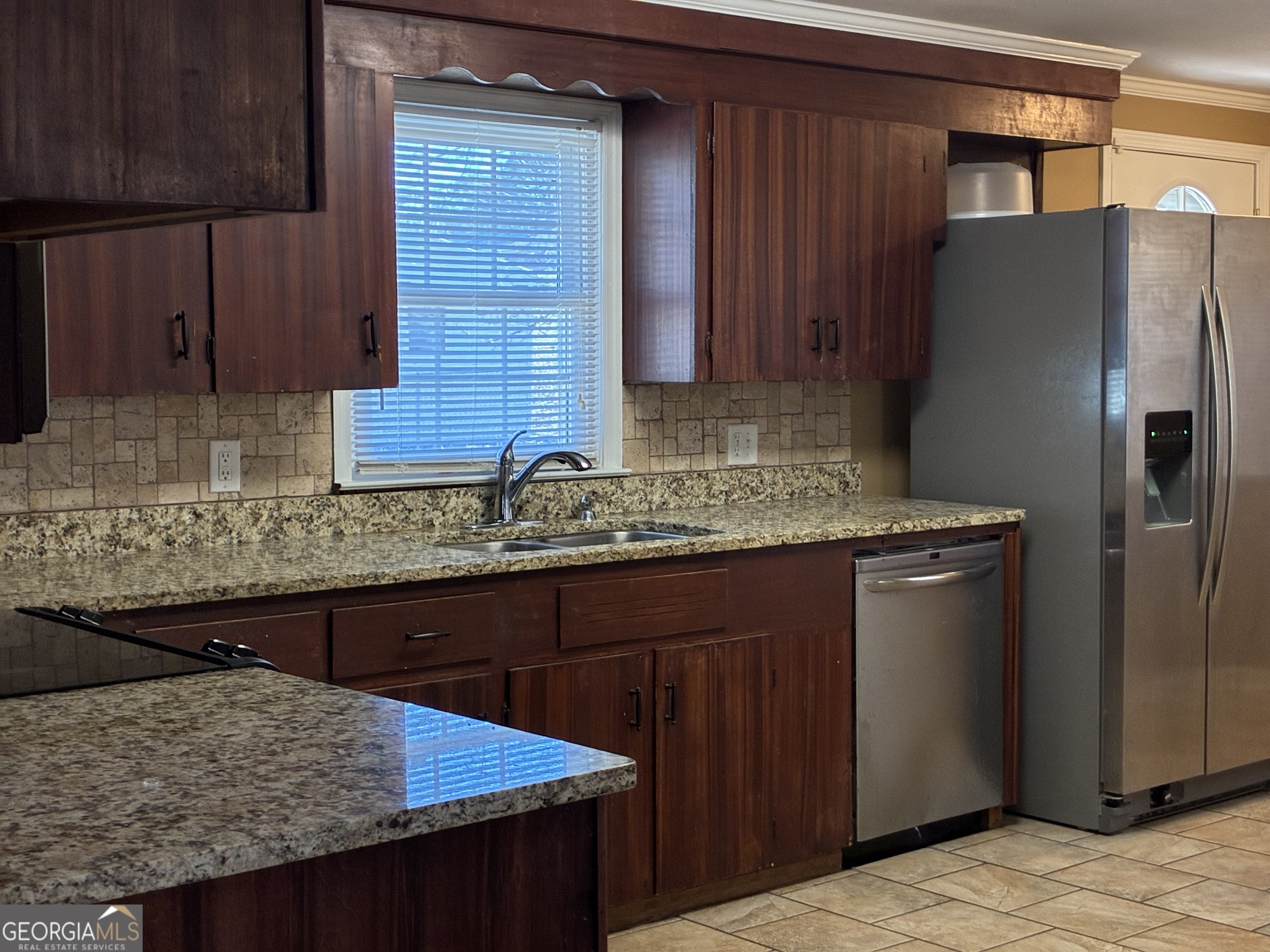 3491 Sandy Circle Macon, GA 31216 - Photo 8 of 49 a kitchen with stainless steel appliances granite countertop wooden cabinets a refrigerator and a sink