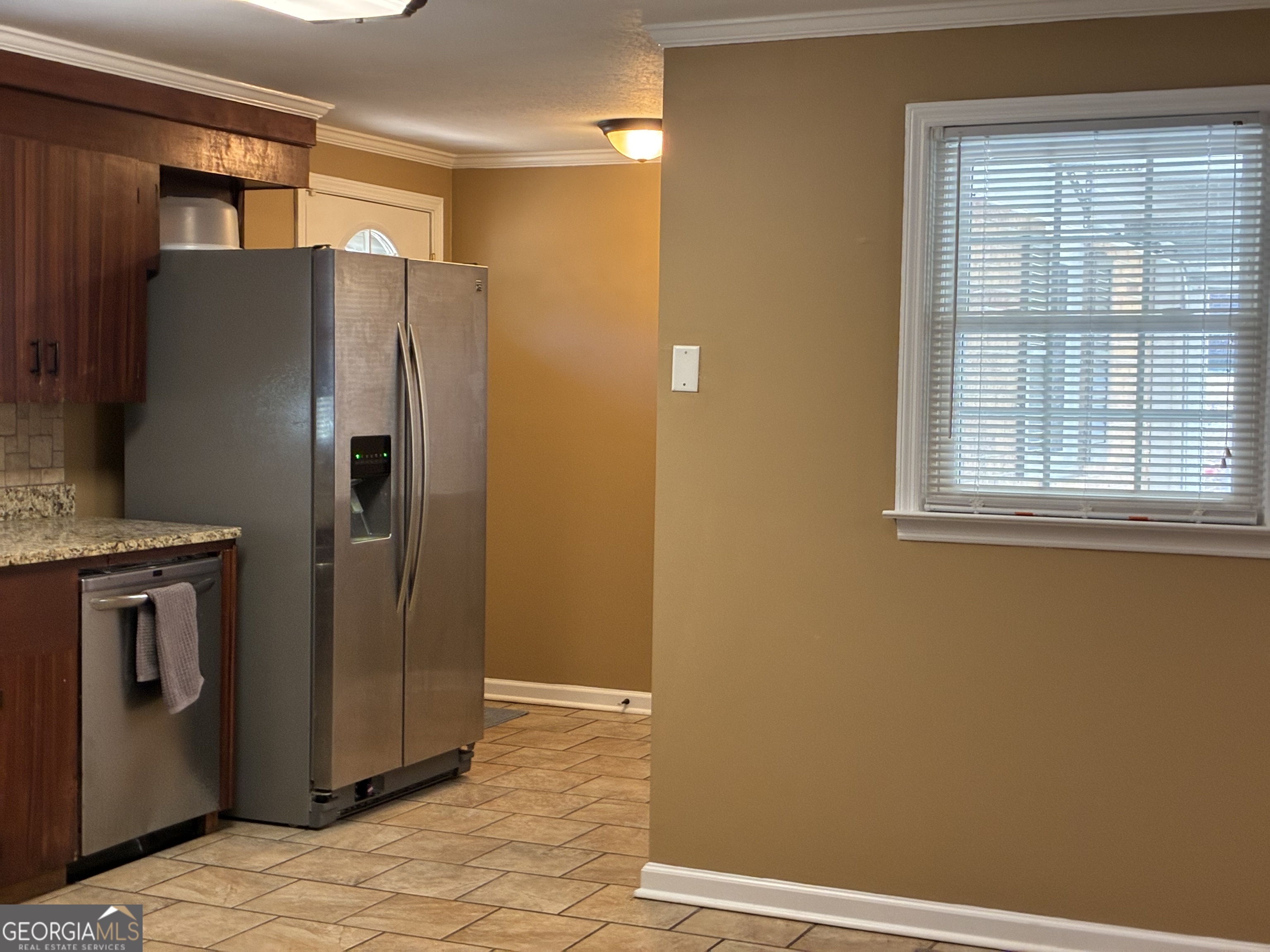 3491 Sandy Circle Macon, GA 31216 - Photo 9 of 49 a metallic refrigerator freezer sitting in a kitchen