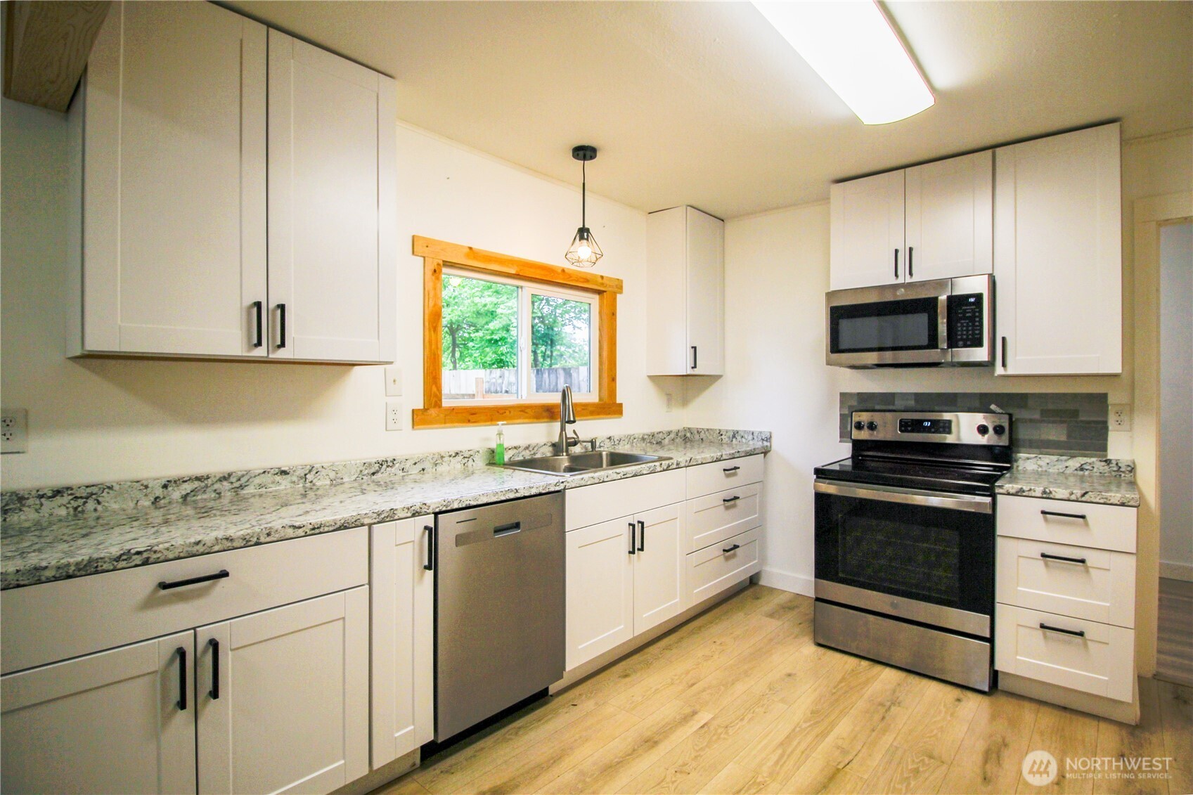 10341 184th Avenue Southwest Rochester, WA 98579 - Photo 3 of 36 a kitchen with stainless steel appliances granite countertop a stove a sink and a microwave