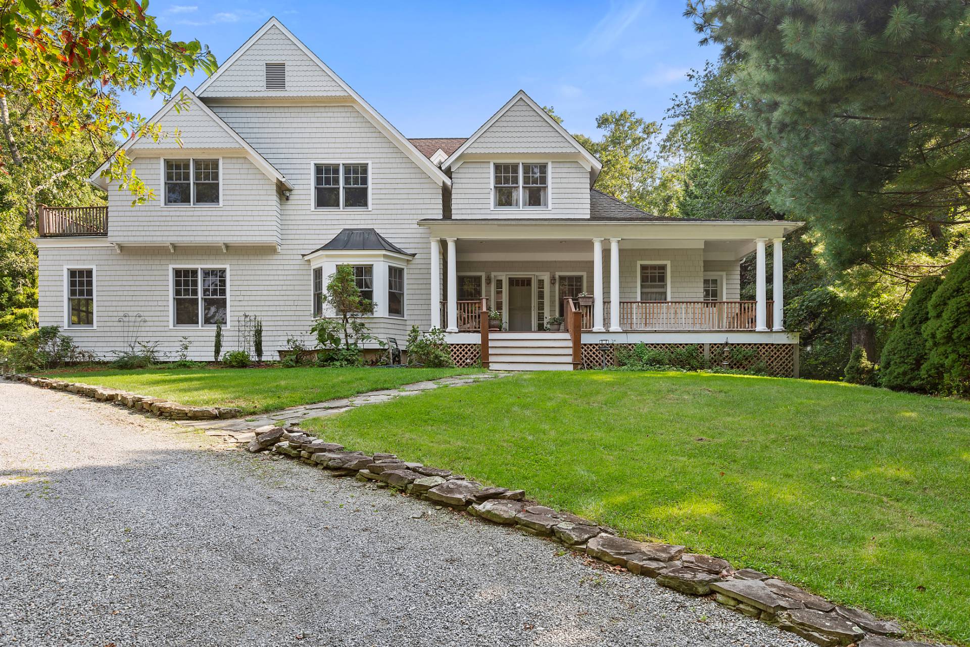 22 Deerwood Path Sag Harbor, NY 11963 - Photo 1 of 18 a front view of a house with a yard and trees