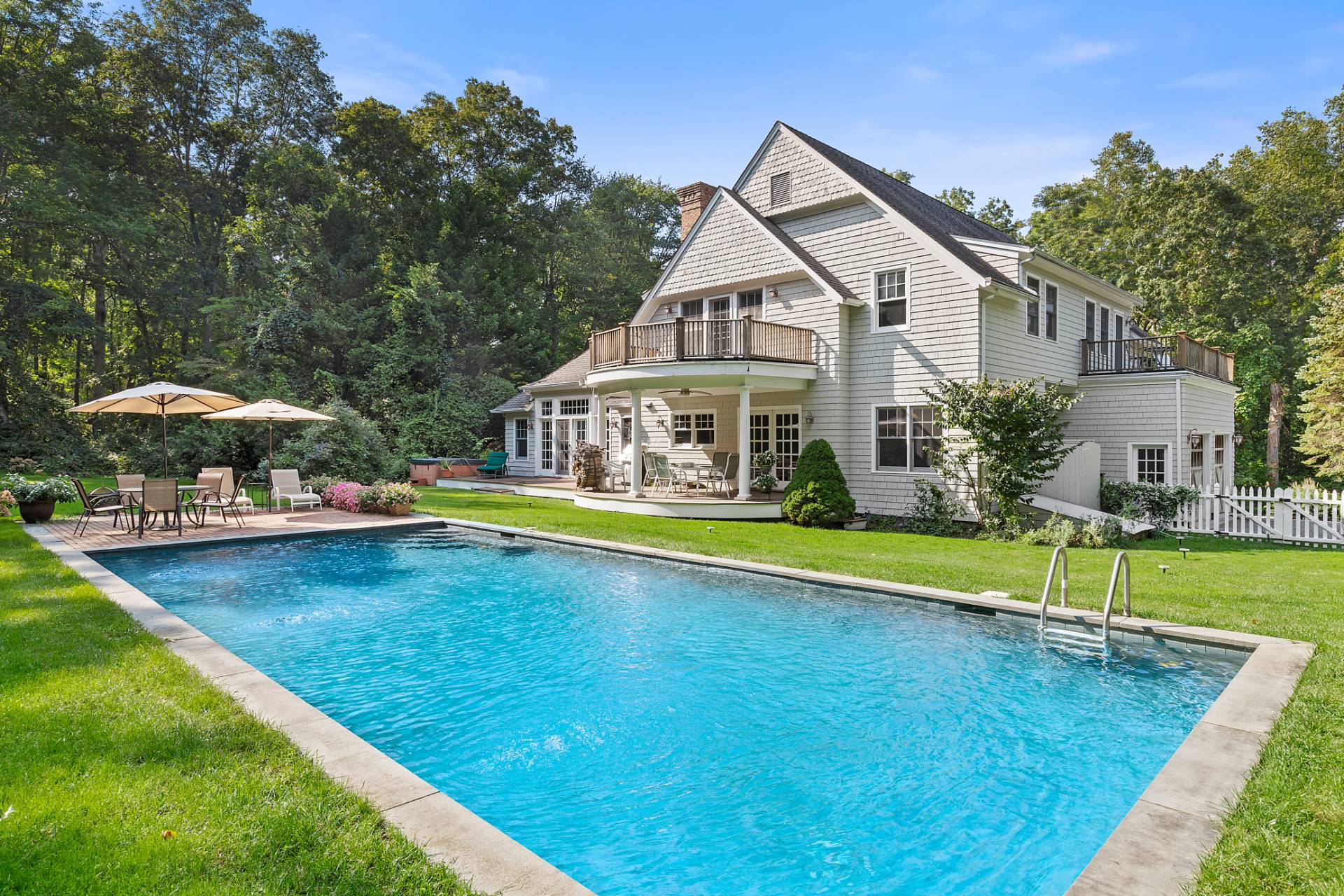 22 Deerwood Path Sag Harbor, NY 11963 - Photo 2 of 18 a front view of house with yard and swimming pool