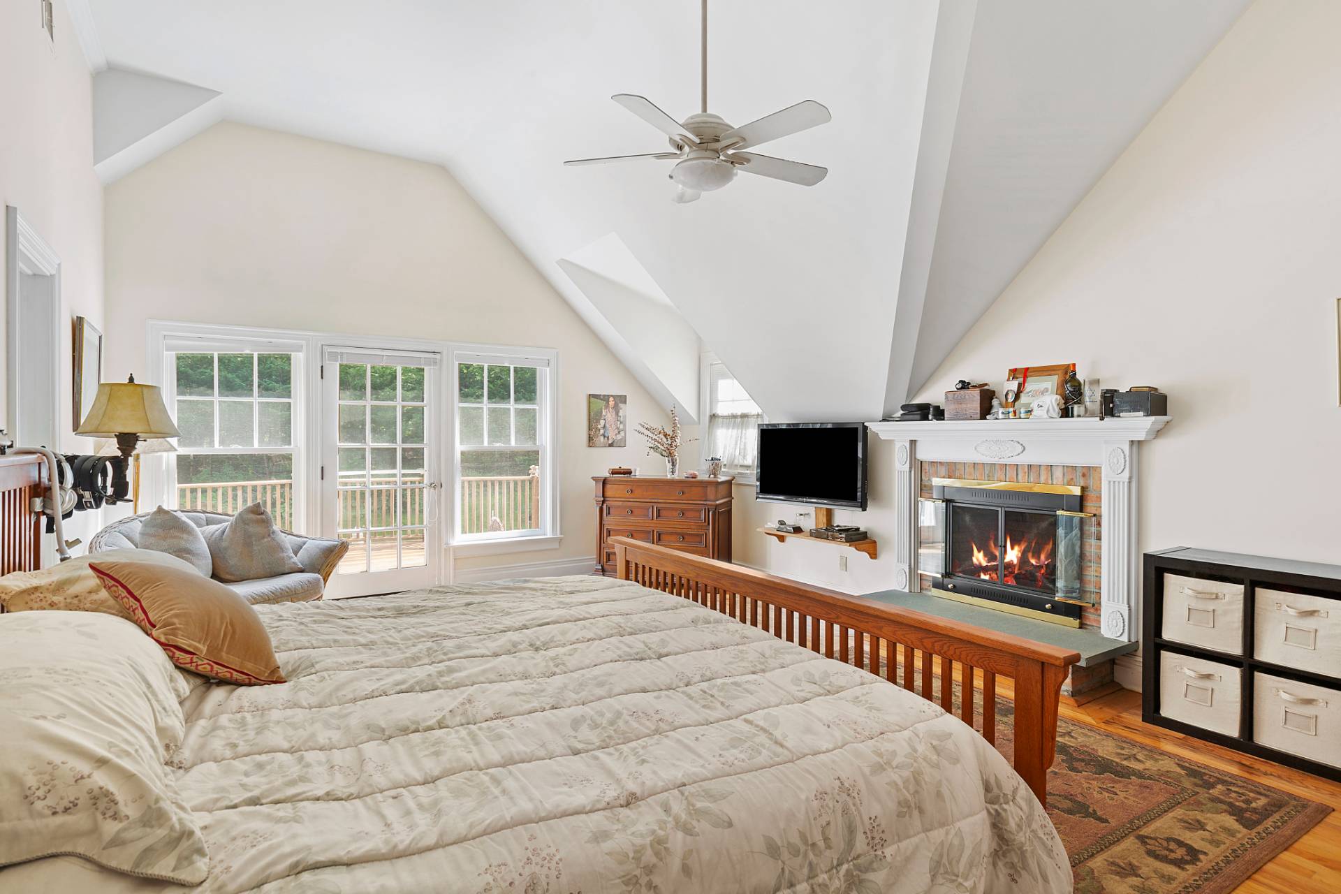 22 Deerwood Path Sag Harbor, NY 11963 - Photo 11 of 18 a bedroom with a bed a window and a fireplace