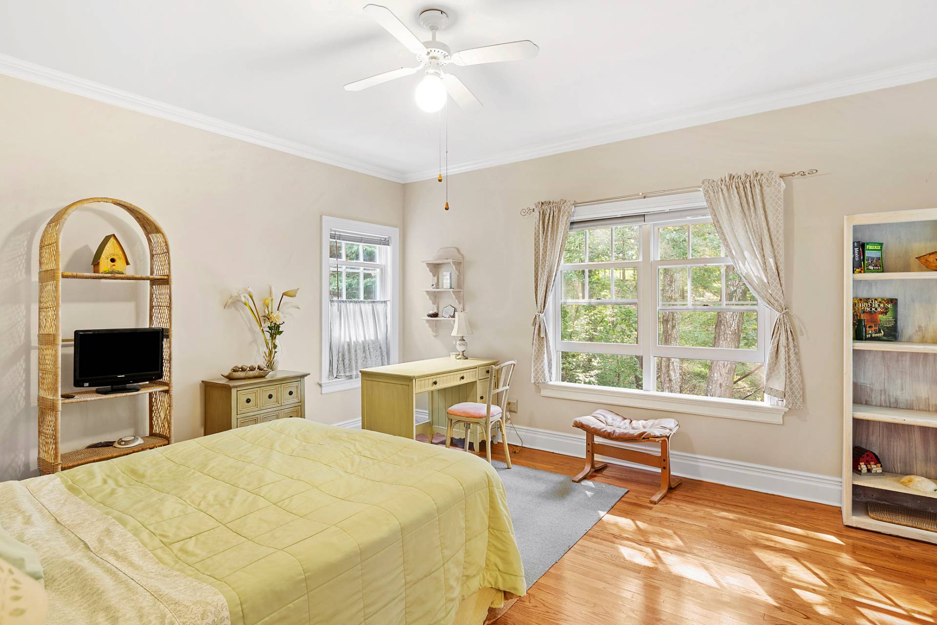 22 Deerwood Path Sag Harbor, NY 11963 - Photo 14 of 18 a bedroom with a bed and a tv on the dresser