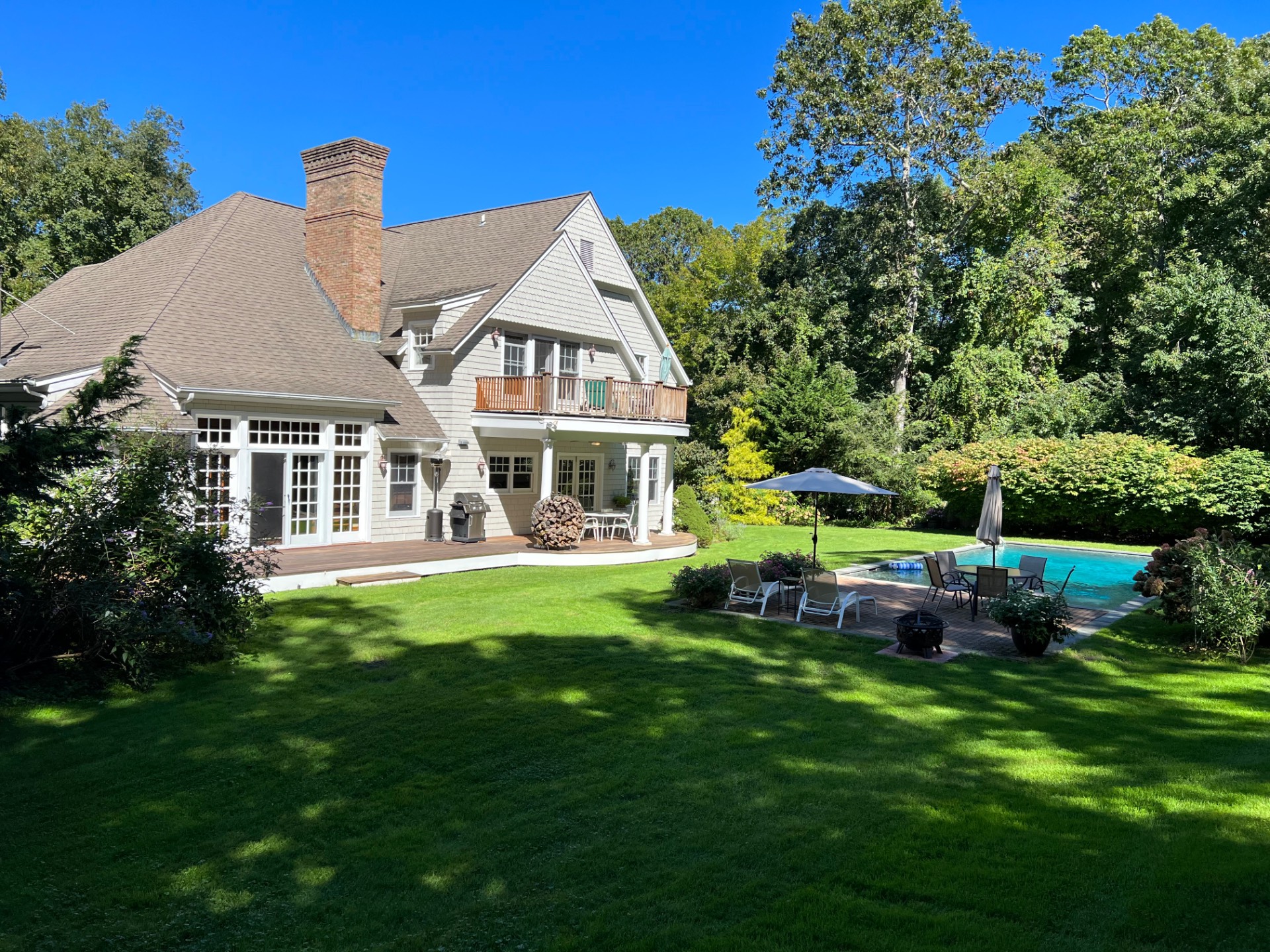 22 Deerwood Path Sag Harbor, NY 11963 - Photo 17 of 18 a front view of a house with a garden