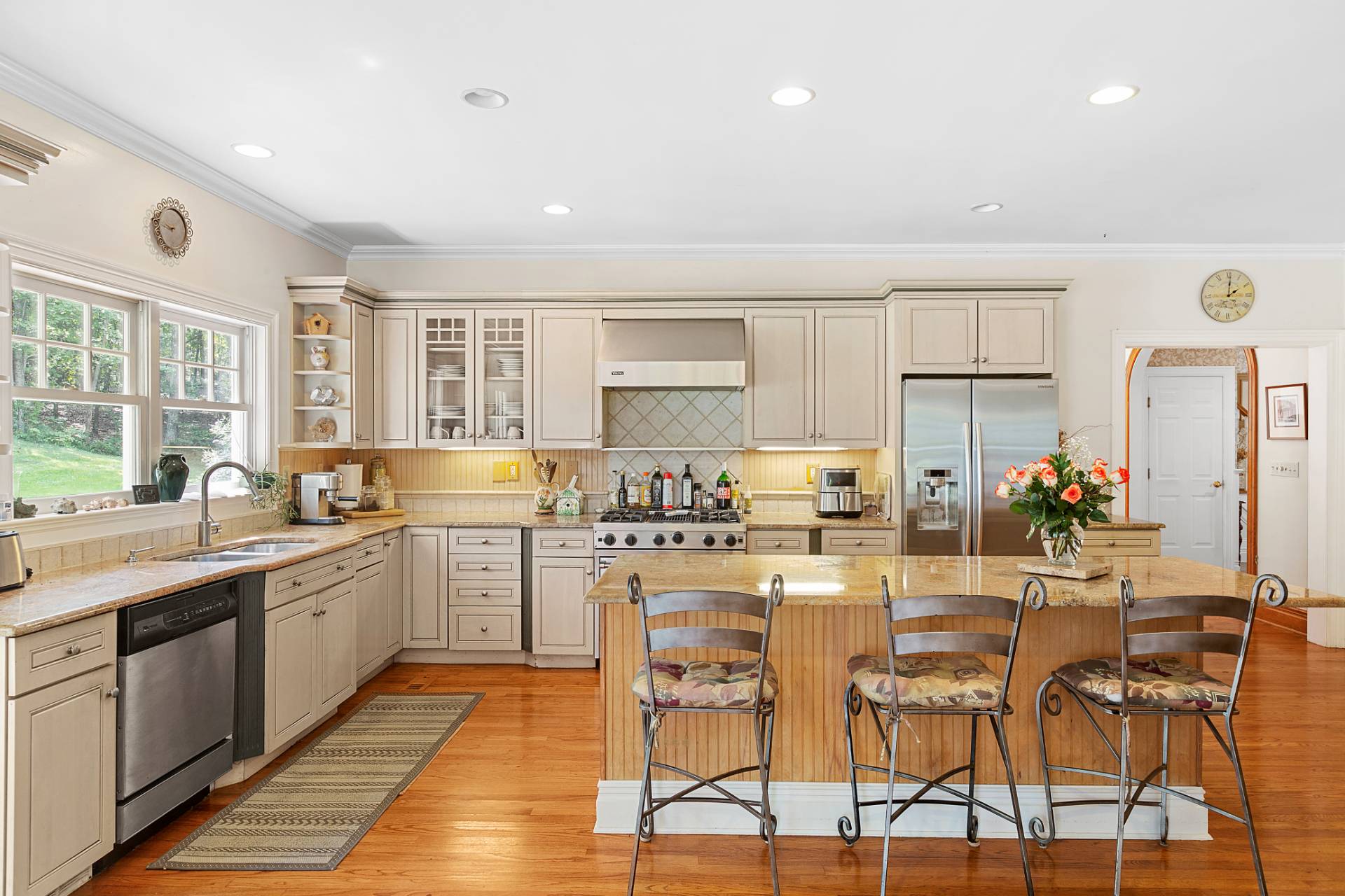 22 Deerwood Path Sag Harbor, NY 11963 - Photo 7 of 18 a kitchen with a sink and chairs
